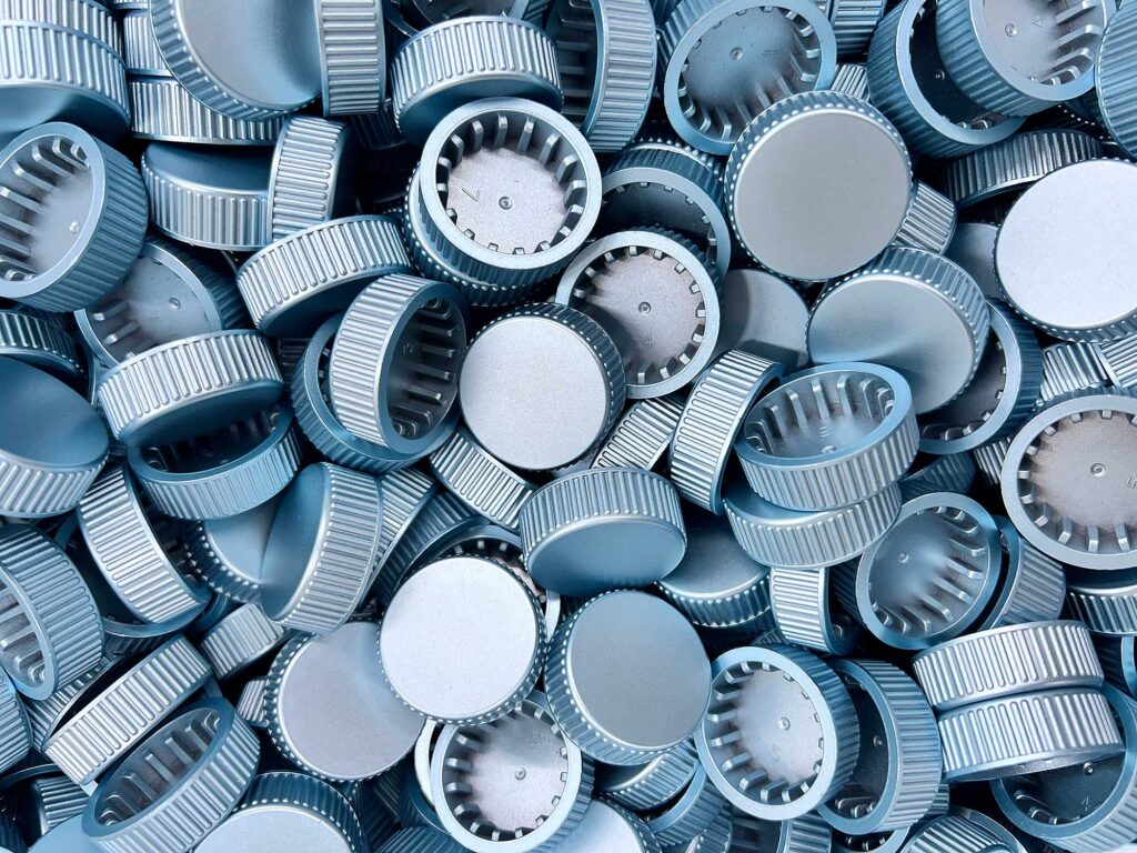 Polystyrene bottle caps coated with 2K metal effect lacquer Light Blue